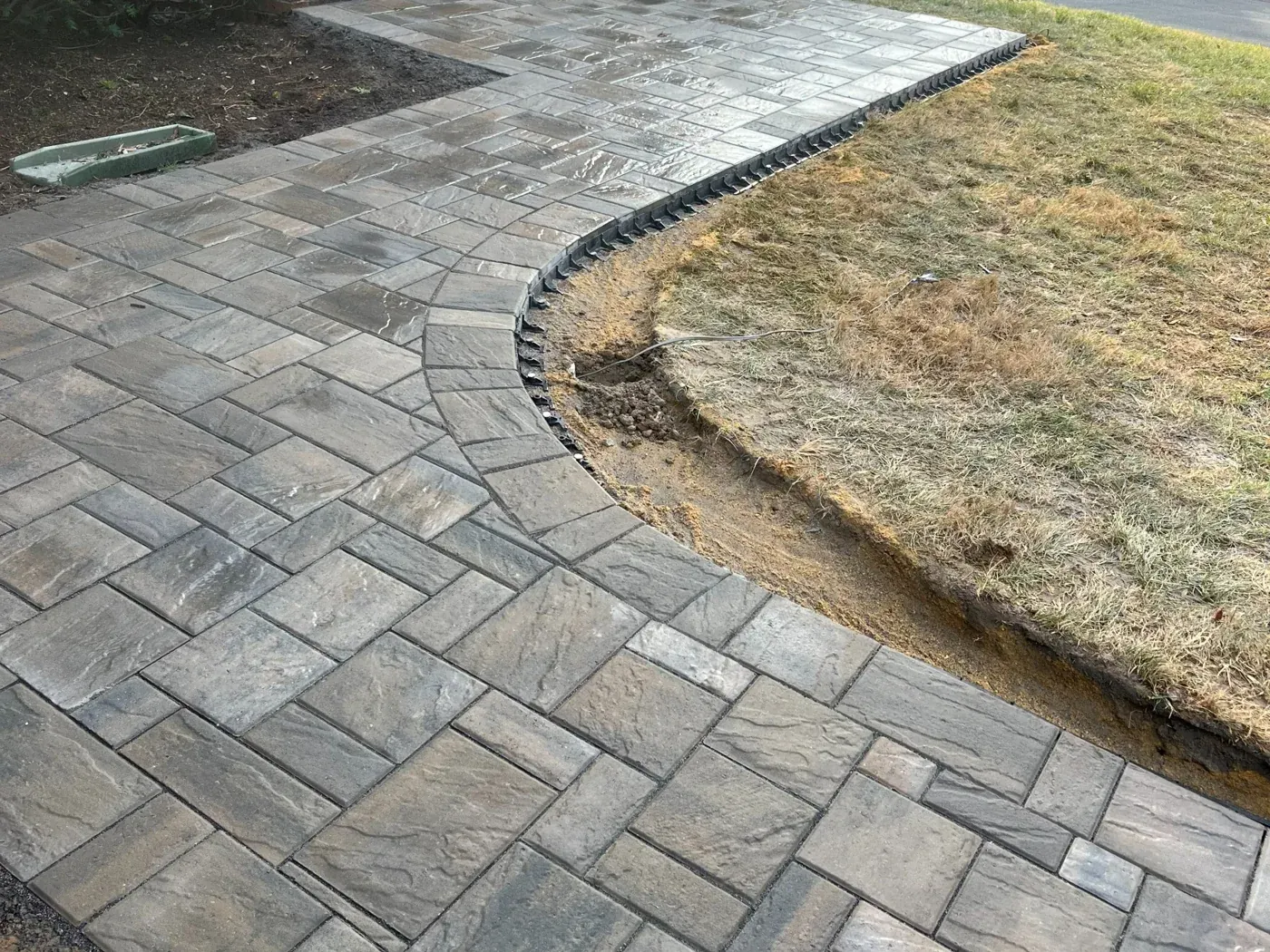 Paver walk curving to the street with a soldier border