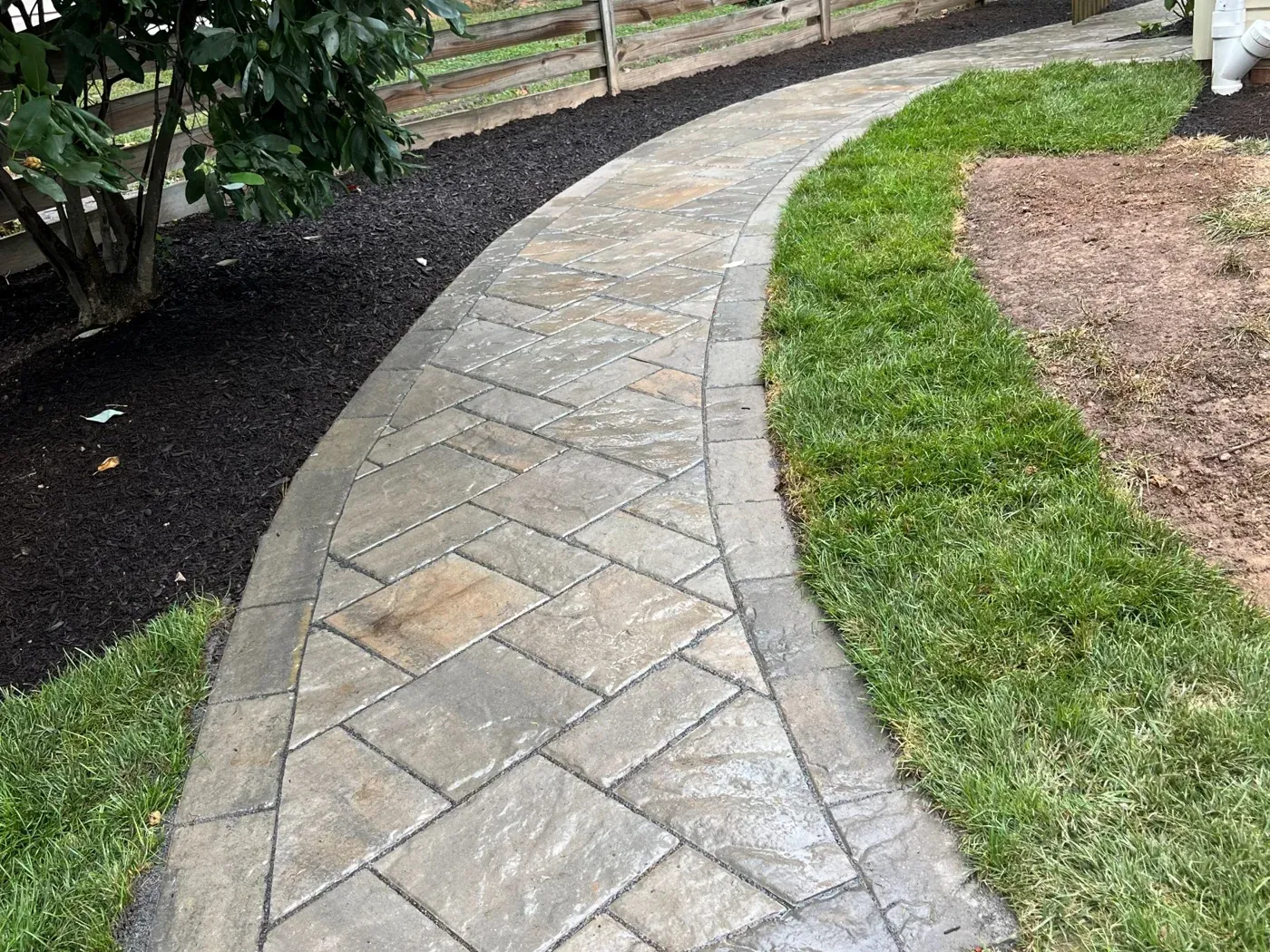 Paver walk running alongside the fence