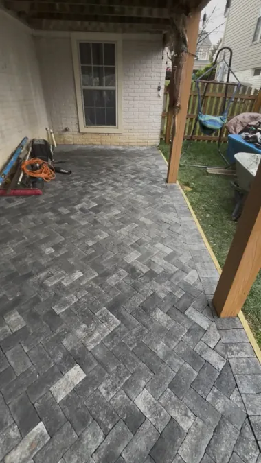 Herringbone paver patio under the deck
