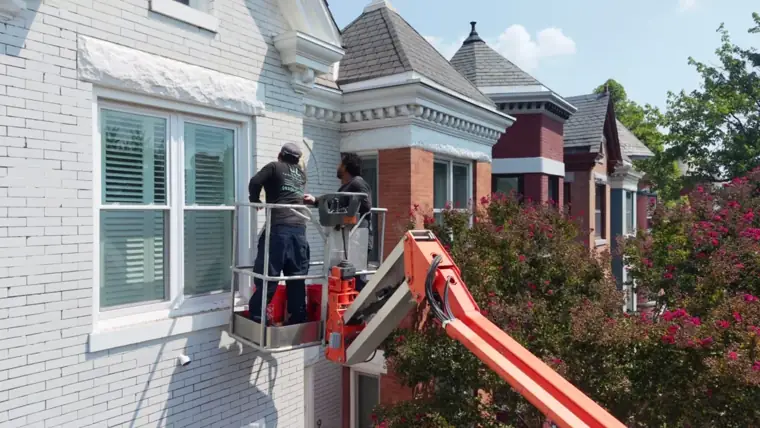 Boom lift up at the roofline on a city street